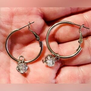 Silver-tone hoop earrings with dangling faceted crystal bead